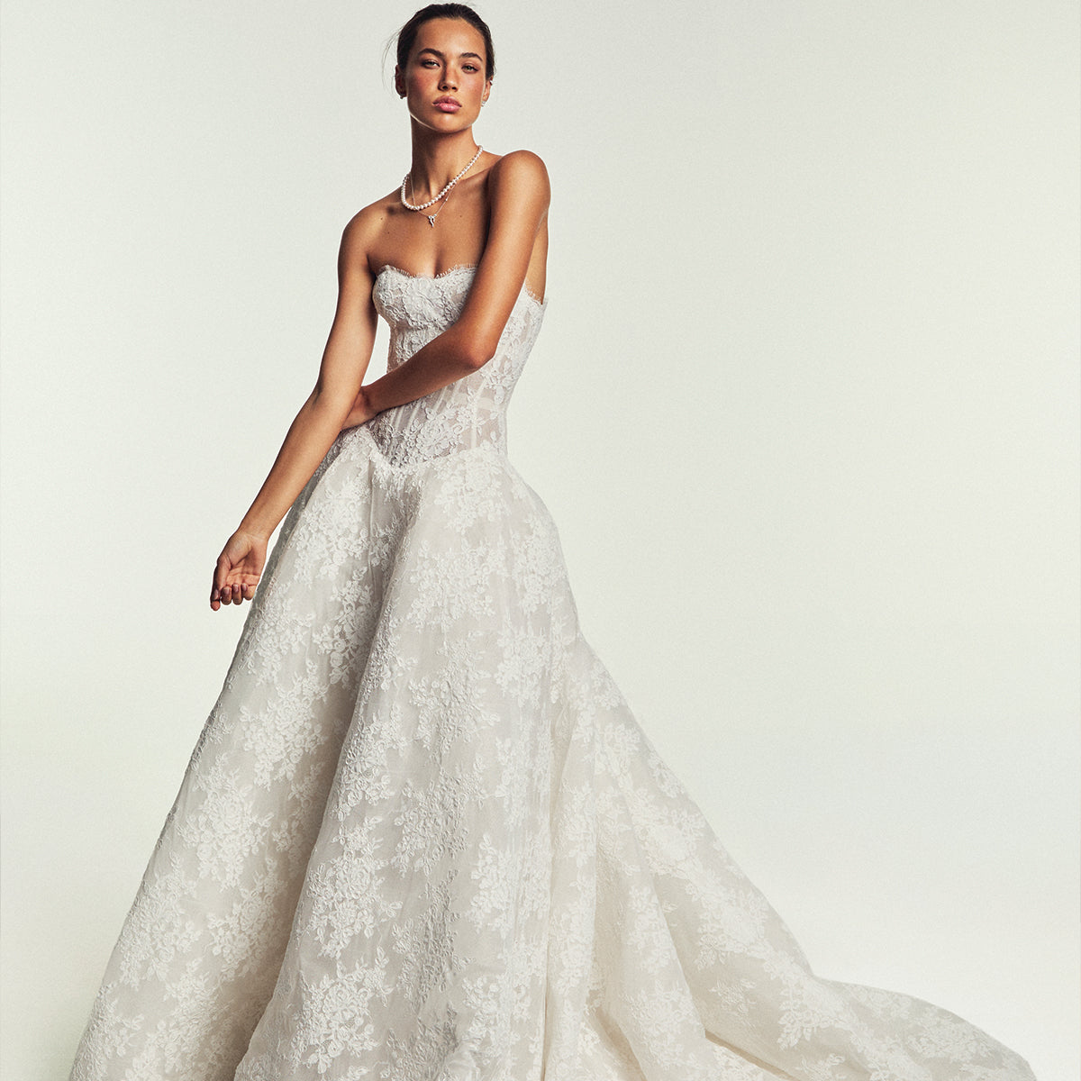 Monique Lhuillier Spring 2027 Bridal Strapless corseted basque waist Beloved ball gown in silk white re-embroidered lace.
