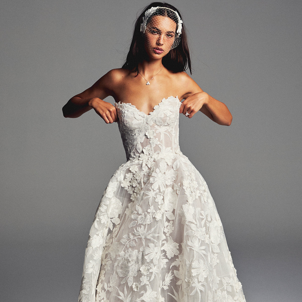 Monique Lhuillier Spring 2027 Bridal Strapless sweetheart June ball gown in silk white three-dimensional embroidered lace.