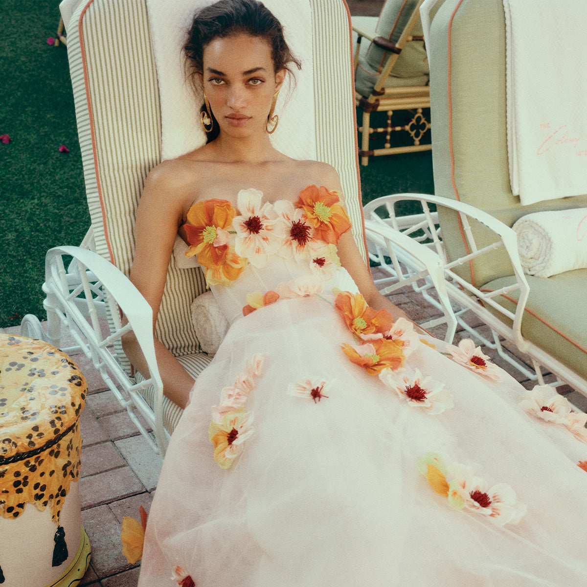 Monique Lhuillier Spring 2025 Ecru/Poppy Poppy Embroidered Tea-Length Dress - lookbook photo of model on loungechair