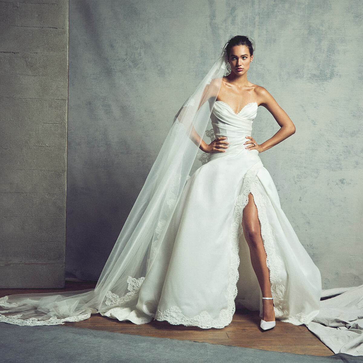 Monique Lhuillier Fall 2027 Bridal Heritage strapless draped ball gown with lace border in silk white satin organza and French re-embroidered lace, and mantilla veil with lace border - lookbook.