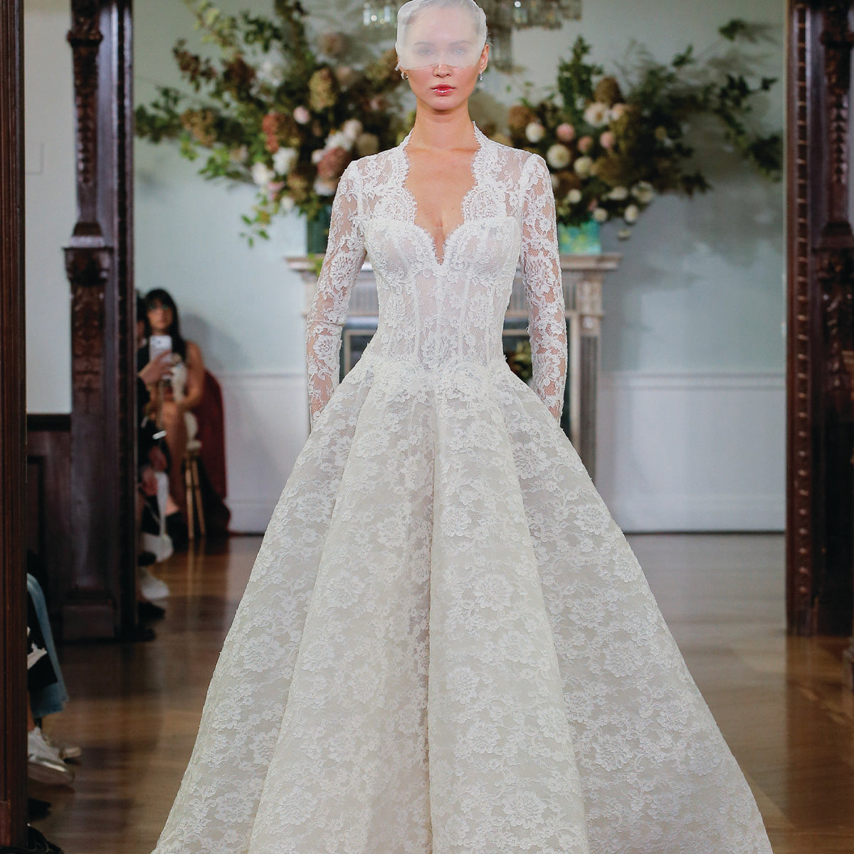 Monique Lhuillier Fall 2026 Bridal ivory re-embroidered lace scalloped v-neck long sleeve Divinity ballgown with dropped waist and structured skirt - runway.