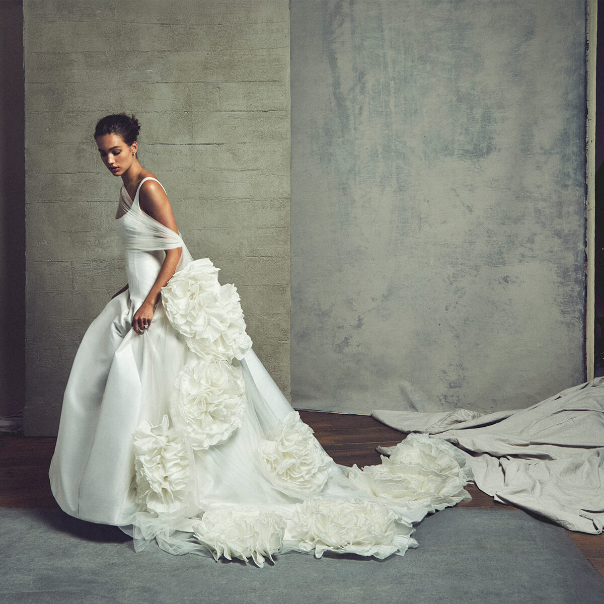 Monique Lhuillier Fall 2027 Bridal Rockwell Sleeveless scooped modified A-line gown in silk white Mikado with floral applique tulle wrap - lookbook. 
