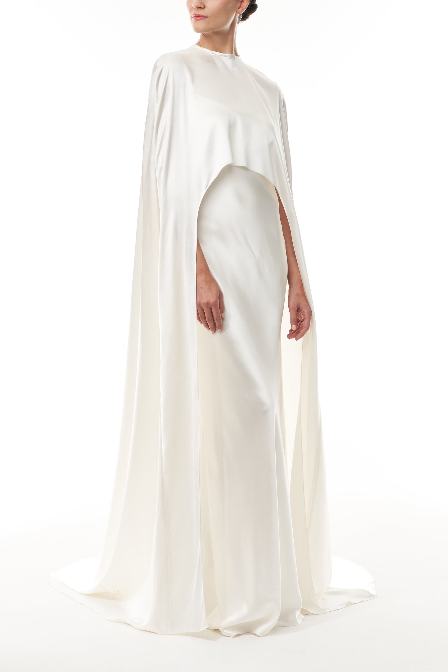 Silk white satin "Viola" cape with long back train and rounded front.  Shown over the Viola silk white satin floor length gown - side.