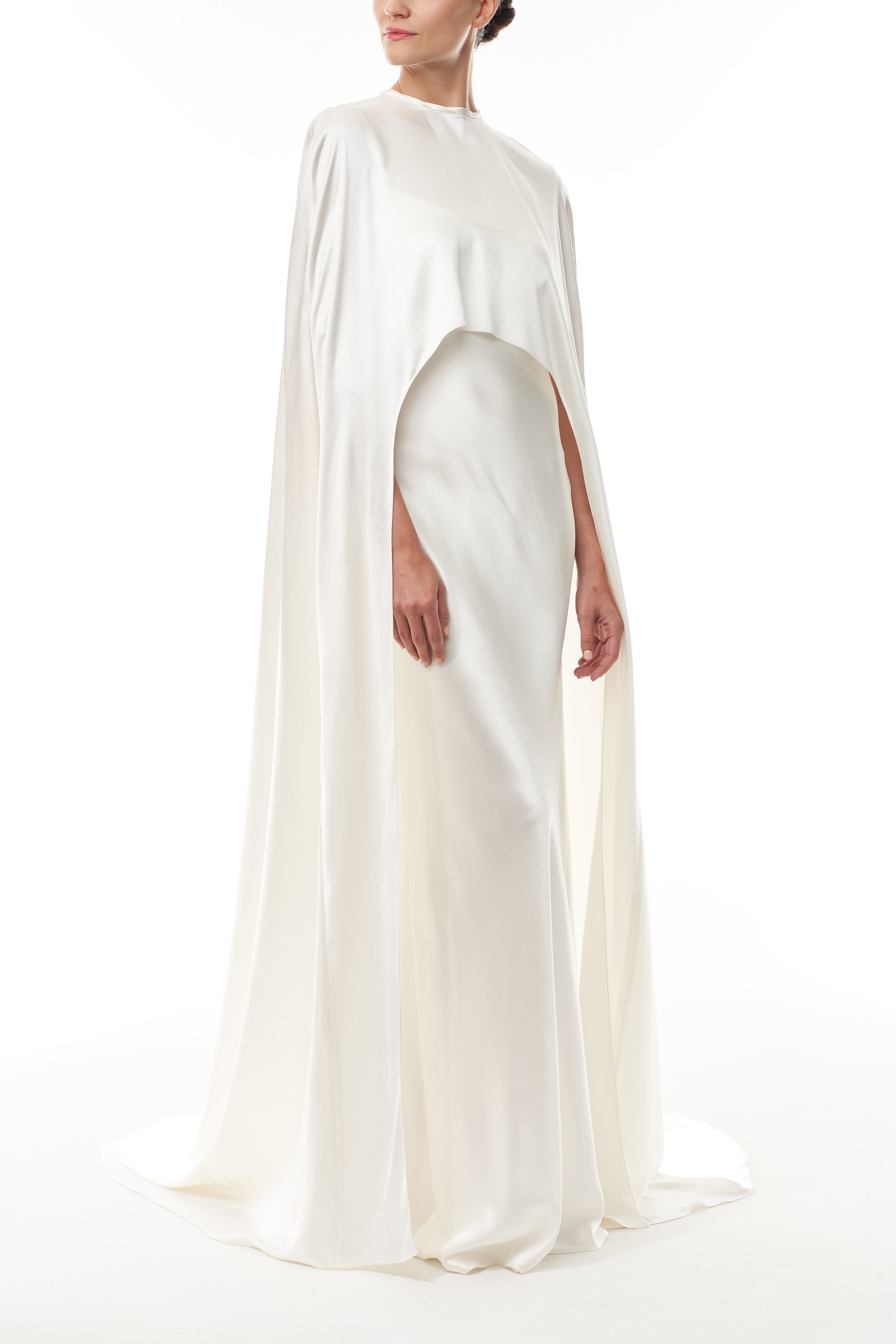 Silk white satin "Viola" cape with long back train and rounded front.  Shown over the Viola silk white satin floor length gown - side.