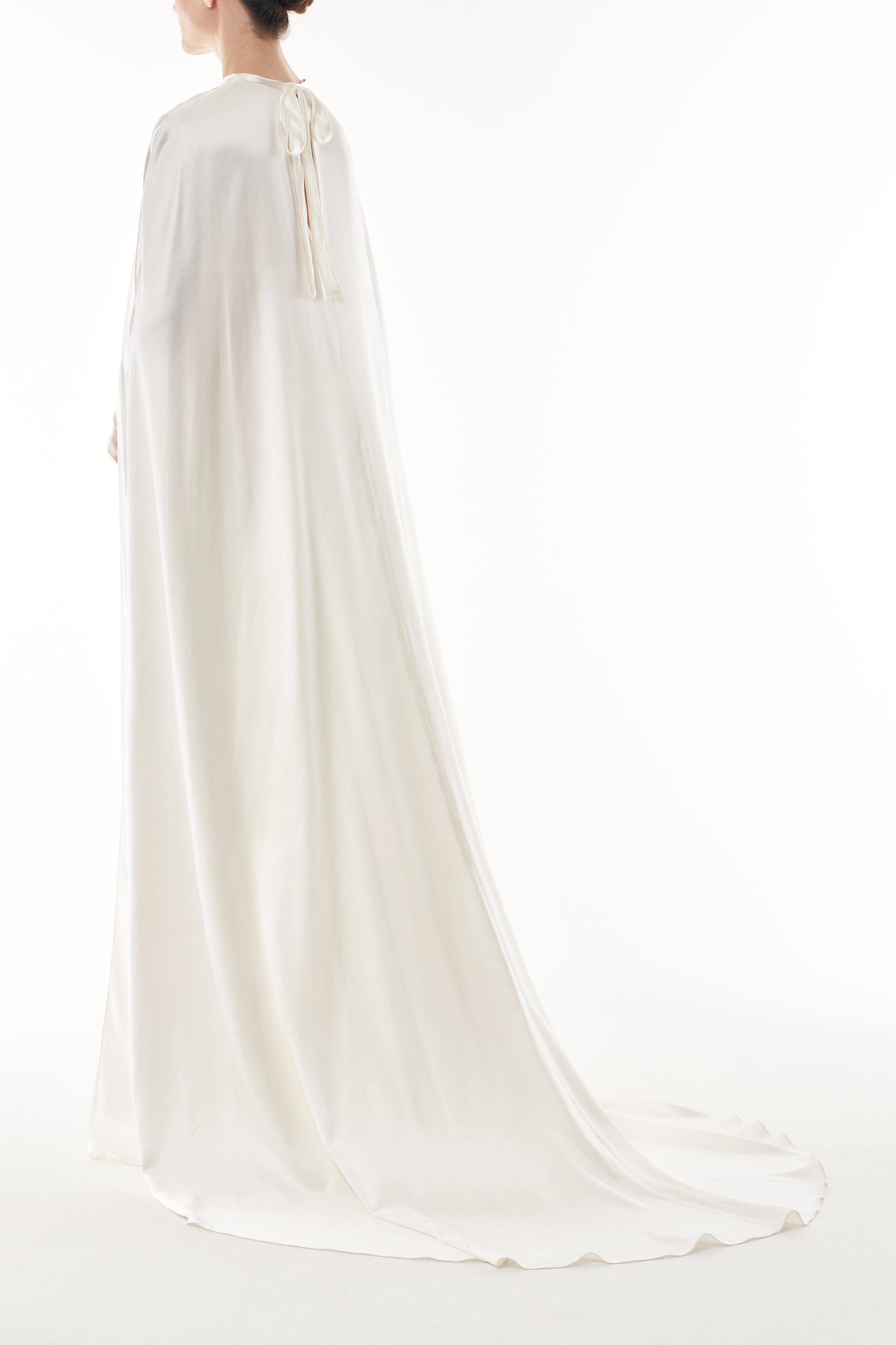 Silk white satin "Viola" cape with long back train and rounded front.  Shown over the Viola silk white satin floor length gown - back.