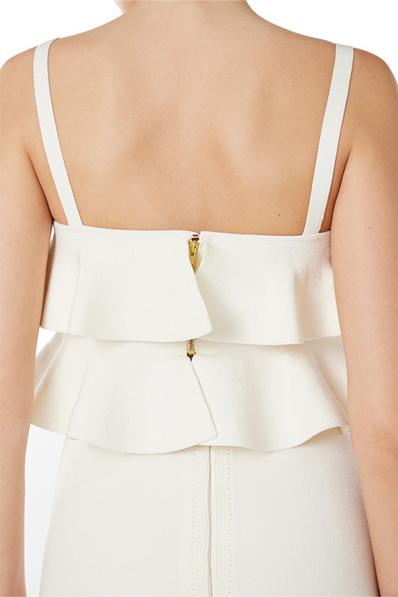 Monique Lhuillier white knit ruffle top with spaghetti straps and back gold zipper.