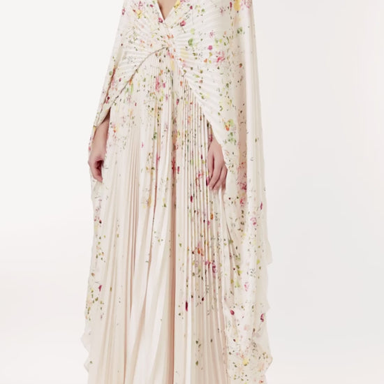 Monique Lhuillier floral printed plisse caftan with deep v neckline and cape sleeves.