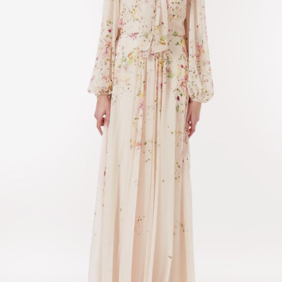 Monique Lhuillier long sleeve gown with attached necktie and gathered waist in buff floral printed chiffon.