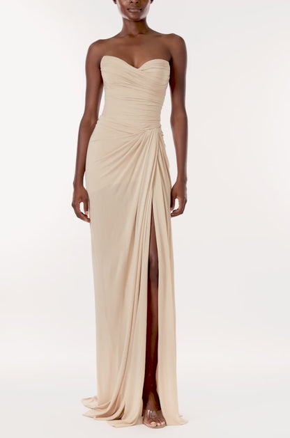 Monique Lhuillier strapless floor length gown with sweetheart neckline and high front leg slit in sand colored matte jersey fabric.