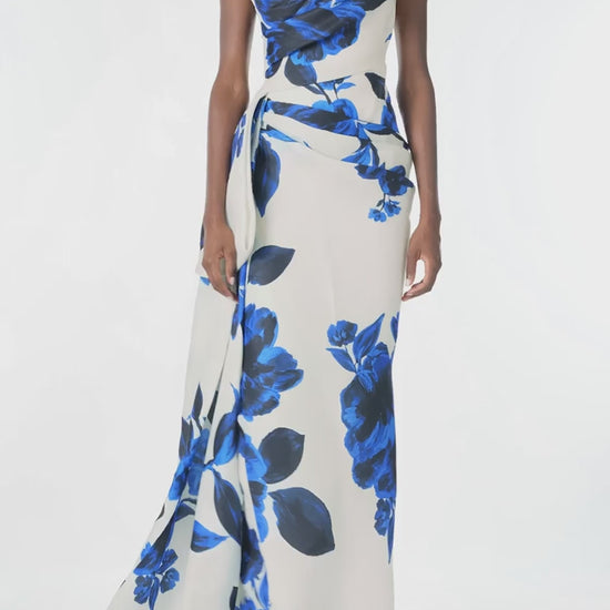 Monique Lhuillier Spring 2025 Strapless, column gown with asymmetric neckline, tufted draping and sweeping side train in Nautical Blue Floral printed gazar - video.