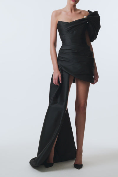 Monique Lhuillier Spring 2026 Stretch Mikado Noir Asymmetric drape mini
dress with train with pearl ball piercing - video.