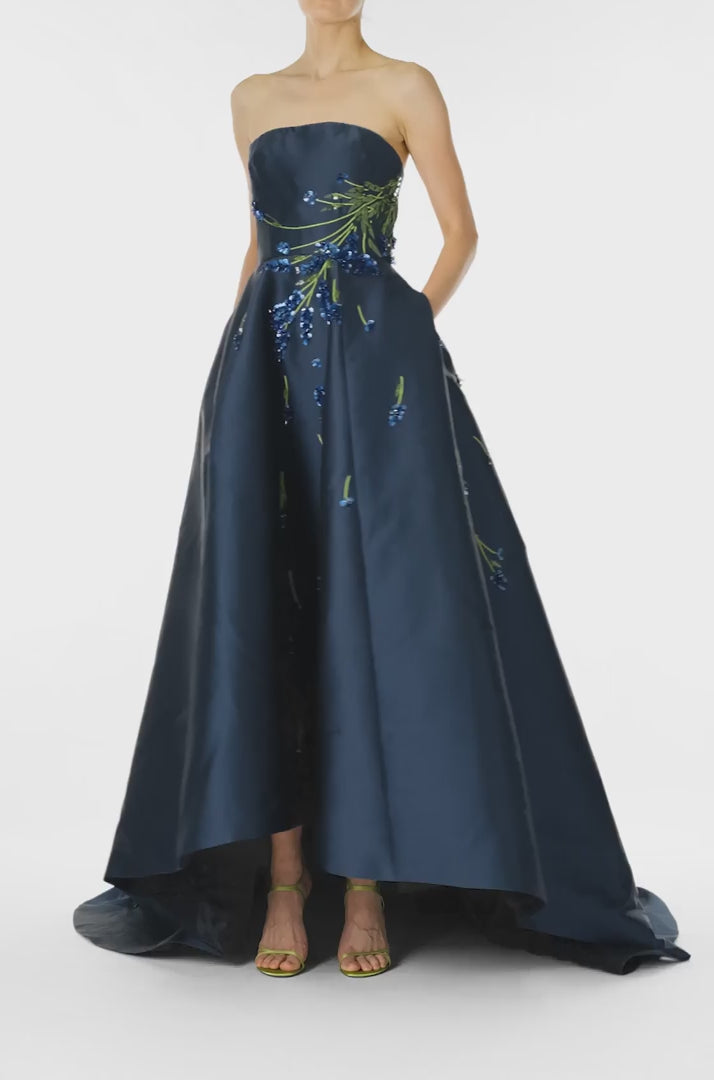 Monique Lhuillier Spring 2025 Strapless ball gown with high-low hemline and pockets in Lapis Mikado/Lavender embroidery - video.