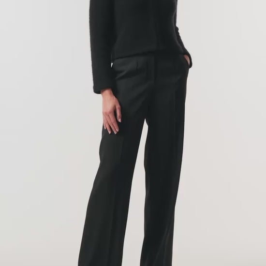 Monique Lhuillier Fall 2026 Noir bouclé knit jacket with crystal trim neckline and hook and eye closures - video.