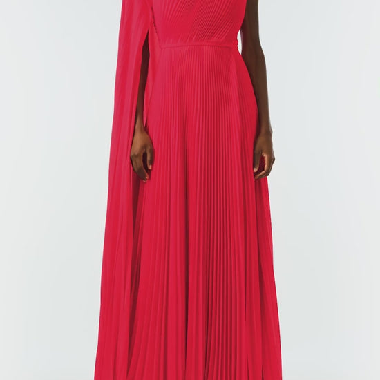 Monique Lhuillier Fall 2024 One shoulder gown with attached, asymmetric-pleated cape in Scarlet Georgette - video.