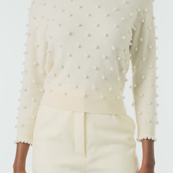 Monique Lhuillier Fall 2024 creme cashmere long sleeve sweater with pearl embroidery and trim - video.