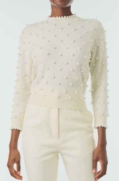 Monique Lhuillier Fall 2024 creme cashmere long sleeve sweater with pearl embroidery and trim - video.