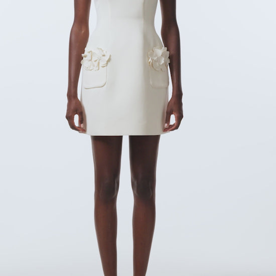 Monique Lhuillier Spring 2026 Ivory Lighweight Silk Wool Suiting Scoop neck dress with floral pockets - video.