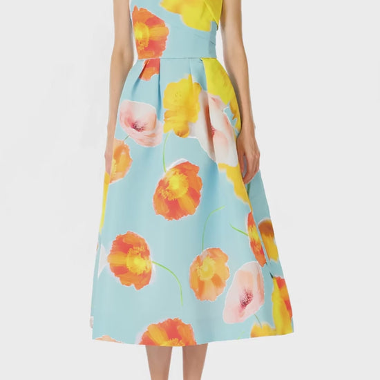 Monique Lhuillier Spring 2025 Strapless tea-length dress with draped bodice and pleated skirt in poppy printed blue faille fabric - video.