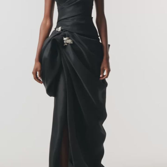 Monique Lhuillier Fall 2026 Noir Gazar strapless draped gown with sculpted skirt and silver floral embellishment - video.