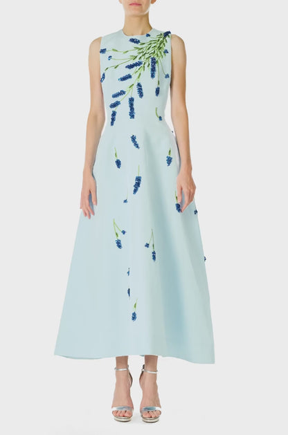 Monique Lhuillier Spring 2025 Sleeveless, tea-length dress with pockets in Powder Blue faille with Lavender-patterned embroidery - video.