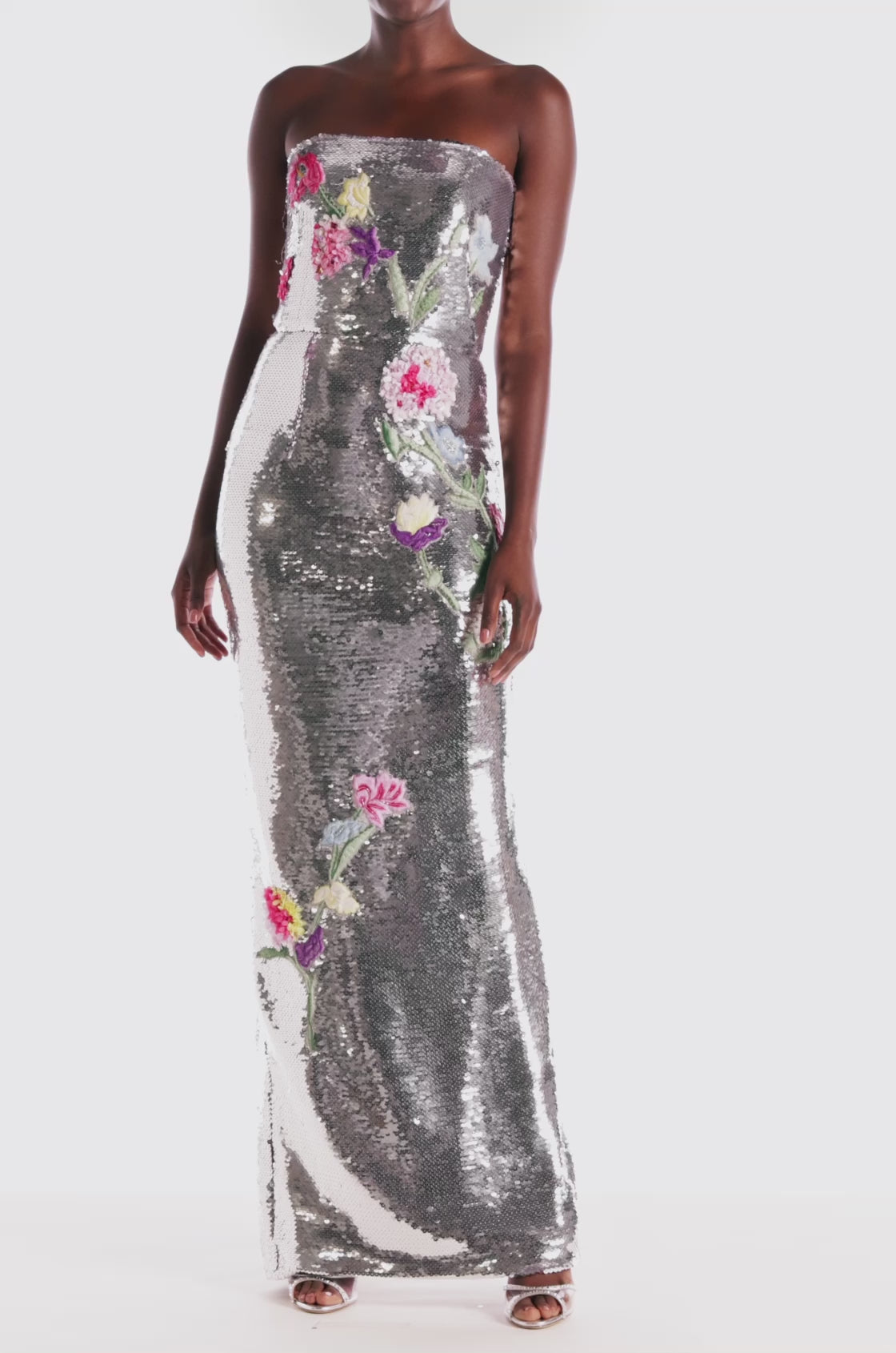 Monique Lhuillier strapless silver sequin column gown with floral embroidery.
