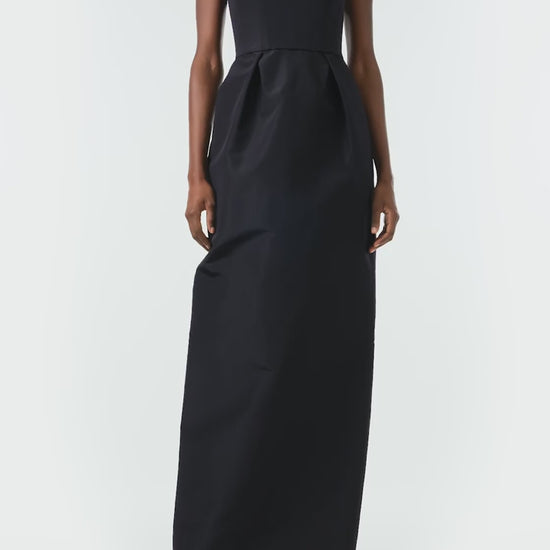 Monique Lhuillier Fall 2024 sleeveless, illusion neckline column gown in noir faille fabric with pearl embroidery and pockets - video.