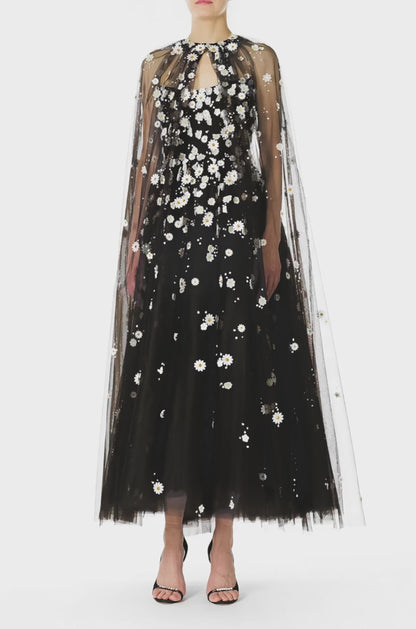 Monique Lhuillier Spring 2025 Noir tulle cape with Daisy embroidery and hook and eye closure at front of neckline - video.