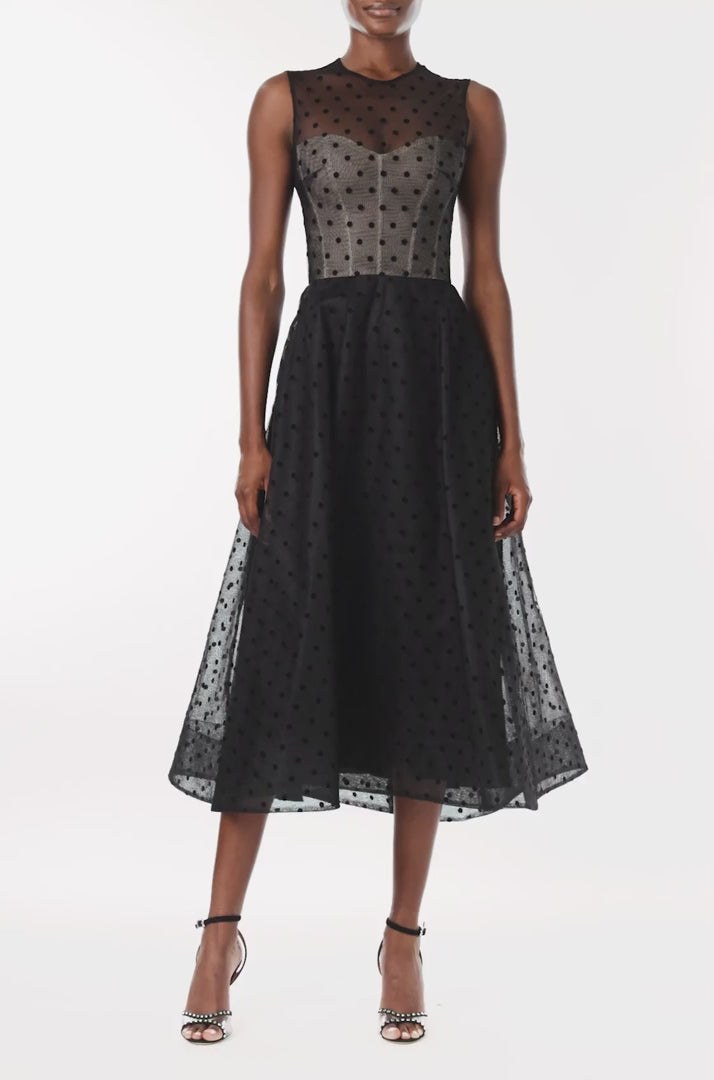 Monique Lhuillier noir dotted tulle, sleeveless jewel neck cocktail dress with caged skirt.