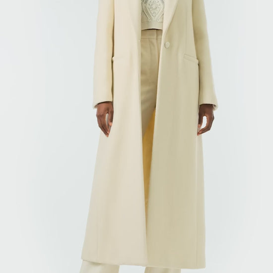 Monique Lhuillier Fall 2024 long sleeve coat in creme colored wool and single closure button - video.