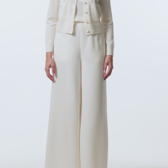 Monique Lhuillier Spring 2026  Ivory Cashmere long sleeve Cardigan with floral embroidery and pockets - video.