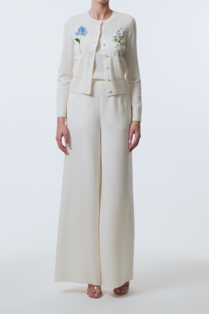 Monique Lhuillier Spring 2026  Ivory Cashmere long sleeve Cardigan with floral embroidery and pockets - video.