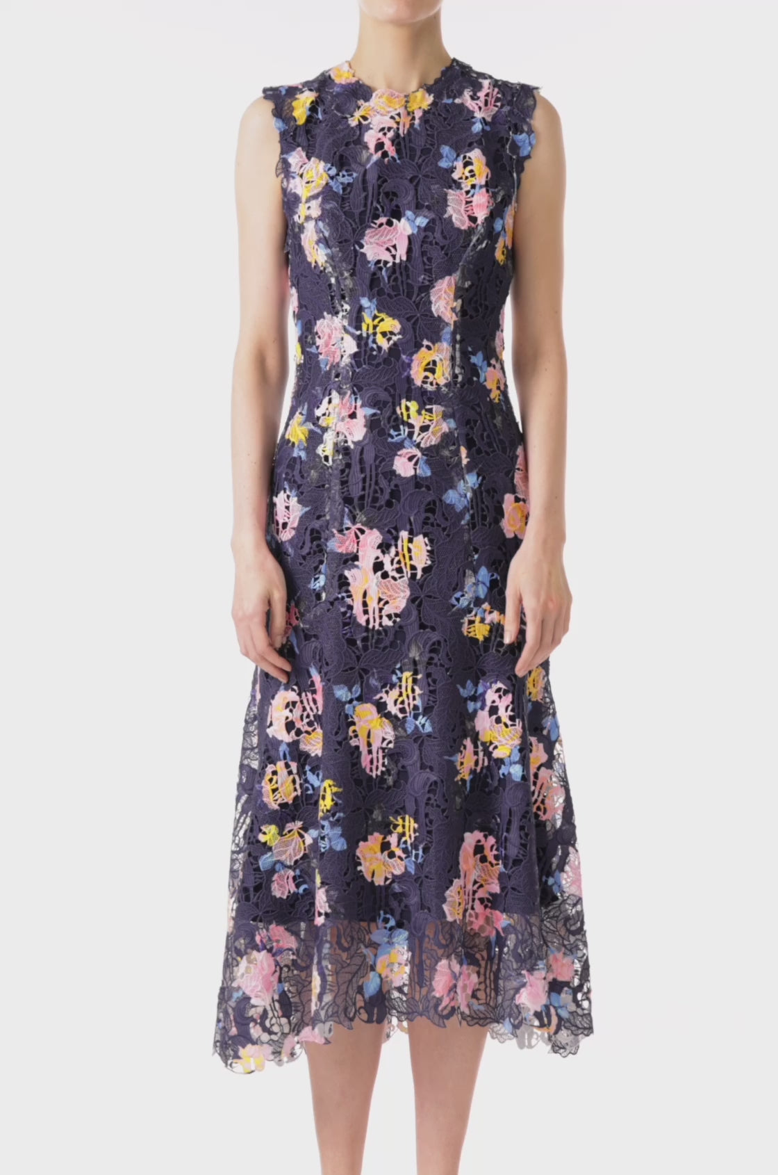 Monique Lhuillier sleeveless, midi-length dress in navy and floral printed lace.