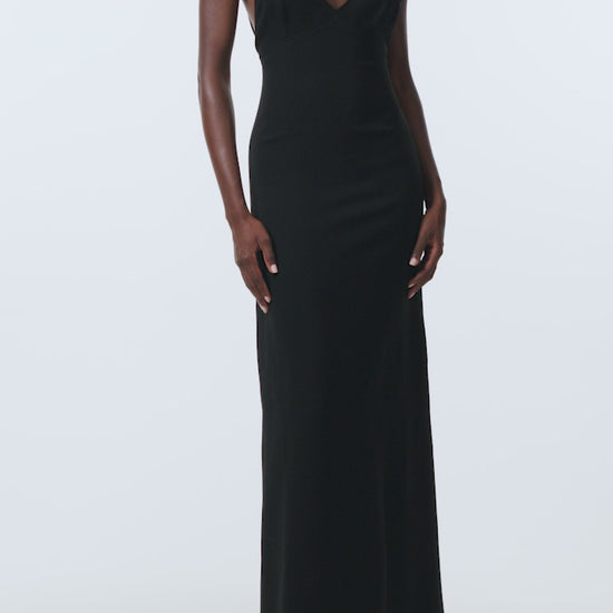 Monique Lhuillier Spring 2026 Noir Lightweight Silk Wool Suiting A - line V -neck gown with pearl ball straps -video.
