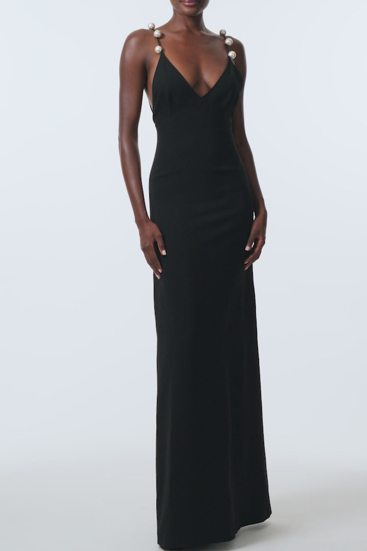 Monique Lhuillier Spring 2026 Noir Lightweight Silk Wool Suiting A - line V -neck gown with pearl ball straps -video.