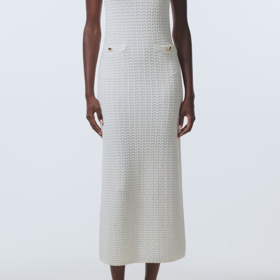Monique Lhuillier Spring 2026 Ivory Cotton Viscose Knit Lace stitch sleeveless dress with gold buttons - video.