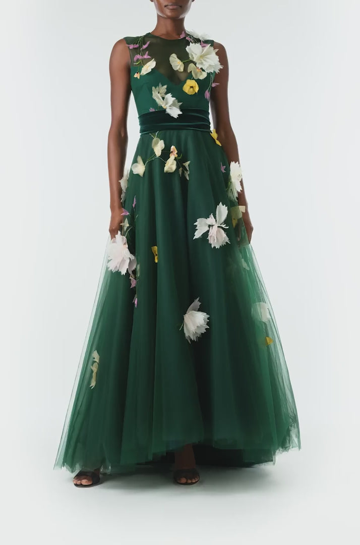 Monique Lhuillier Fall 2024 sleeveless, green tulle gown with floral embroidery, illusion neckline, full A-line skirt and velvet cummerbund at waist - video.