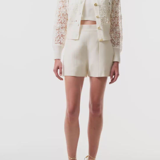 Monique Lhuillier Spring 2025 silk white lace cardigan with gold buttons - video.