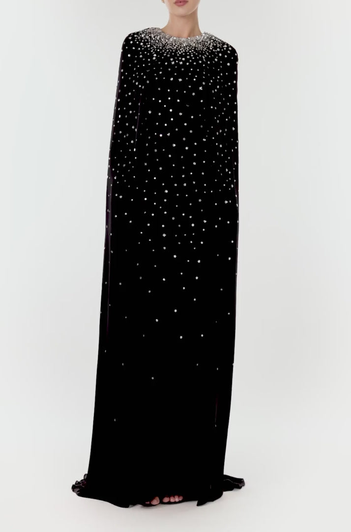 Monique Lhuillier jewel neck, cape gown in Noir chiffon and metallic embroidery.