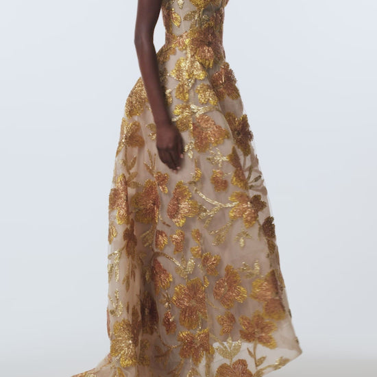 Monique Lhuillier Spring 2026 Gold/Multi Metallic Raffia Floral Embroidered Tulle Strapless ball gown with high-low hem - video.