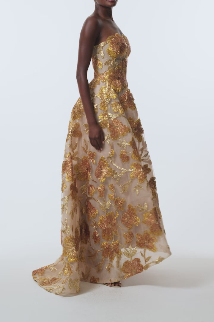 Monique Lhuillier Spring 2026 Gold/Multi Metallic Raffia Floral Embroidered Tulle Strapless ball gown with high-low hem - video.
