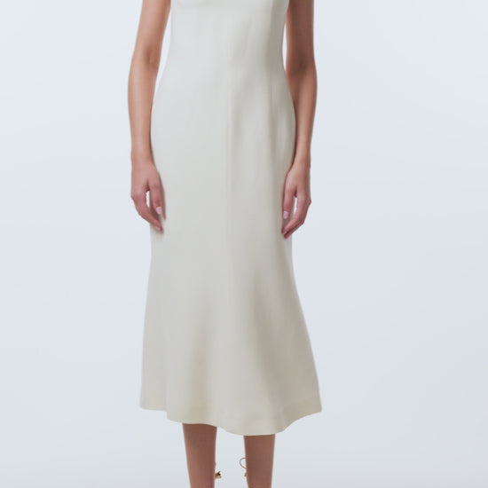 Monique Lhuillier Spring 2026 Ivory Lightweight Silk Wool Suiting Draped neckline dress with gold ball piercing - video.
