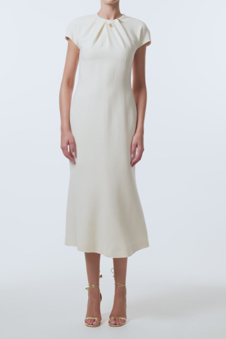 Monique Lhuillier Spring 2026 Ivory Lightweight Silk Wool Suiting Draped neckline dress with gold ball piercing - video.