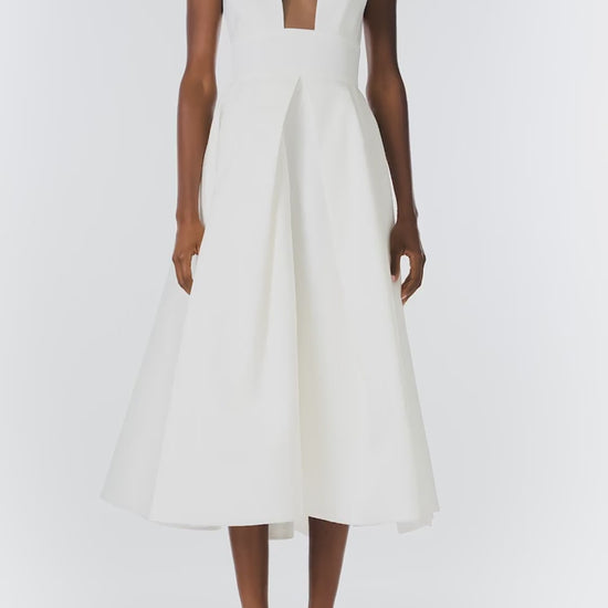 Monique Lhuillier "Kennedy" V-neck cocktail dress in Silk White Mikado fabric with pockets and nude illusion tulle at neckline - video.