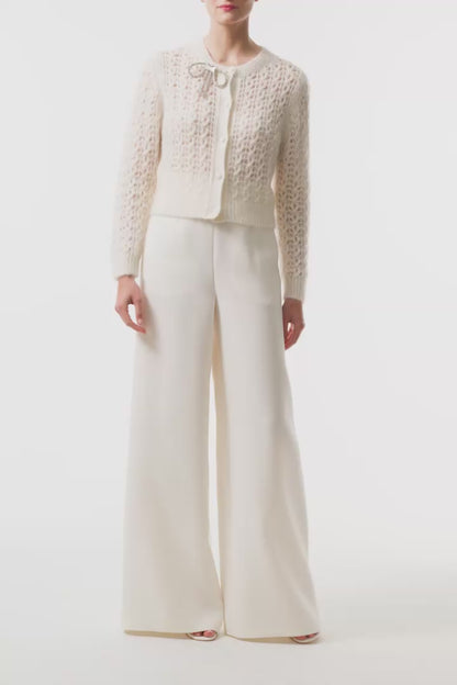 Monique Lhuillier Fall 2025 Mohair Silk Cashmere cardigan with brooch and white wide leg trouser- video.