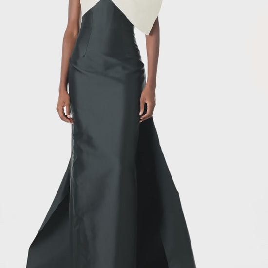 Monique Lhuillier Spring 2025 Strapless column gown with asymmetric draped bow neckline and pleated back train in Noir + Silk White Mikado - video.