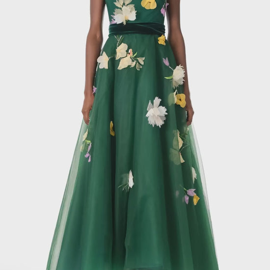 Monique Lhuillier Fall 2024 sleeveless, green tulle gown with floral embroidery, illusion neckline, full A-line skirt and velvet cummerbund at waist - video.