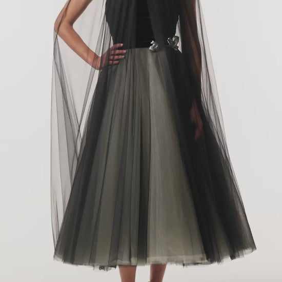 Monique Lhuillier Fall 2026 Noir / multi Stretch Velvet & Tulle strapless tea length dress with floral embellishment and coordinating noir tulle cape - video.