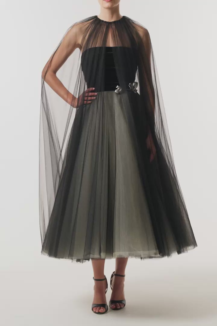 Monique Lhuillier Fall 2026 Noir / multi Stretch Velvet & Tulle strapless tea length dress with floral embellishment and coordinating noir tulle cape - video.