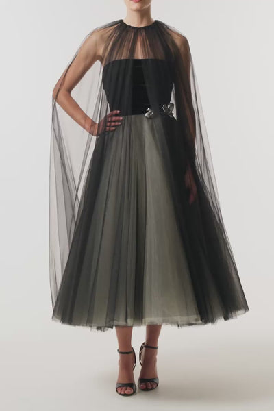 Monique Lhuillier Fall 2026 Noir / multi Stretch Velvet & Tulle strapless tea length dress with floral embellishment and coordinating noir tulle cape - video.
