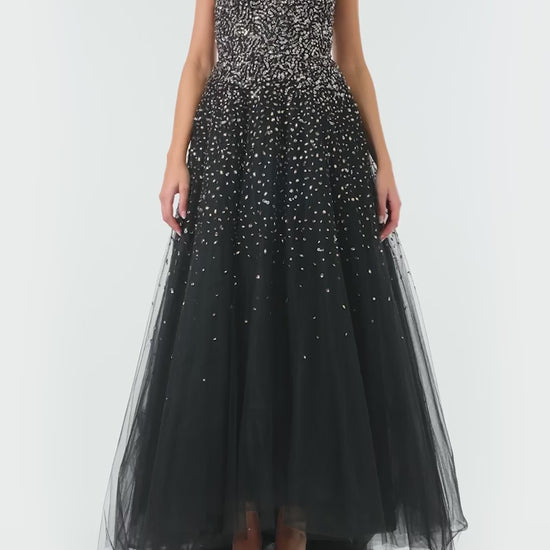 Monique Lhuillier Spring 2024 black tulle gown with metallic embroidery and high-low hem - video.
